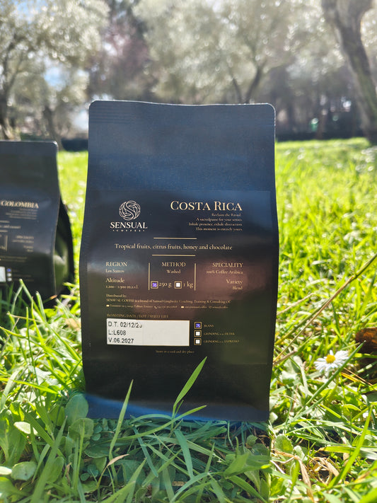Coffee bag labeled 'Costa Rica Sensual Coffee' on grass